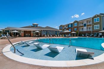 Resort-style swimming pool with sun shelf and expansive sundeck